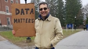 Alan Cobo-Lewis holding a cardboard sign that reads, Data Matters.