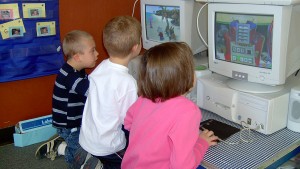 Pre-K students using computers.