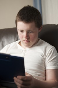 Boy reading from an iPad.