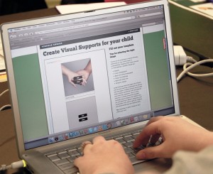 Student reviewing a visual support's paper on a laptop.