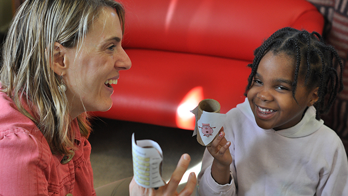 Teacher working with preschooler.