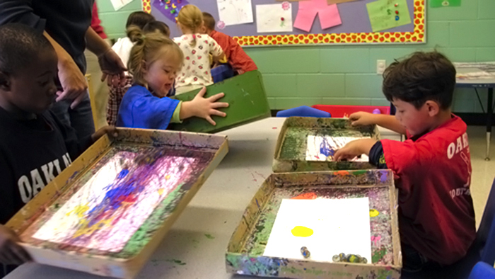 Three preschoolers in art class.