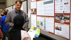 Erik Carter discussting the collaborative poster at the 2016 AUCD conference.
