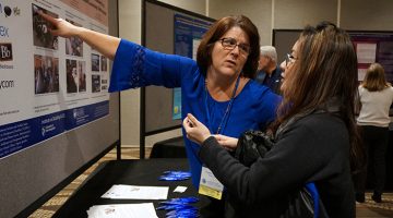 Susan Russell presenting poster at AUCD conference 2016.