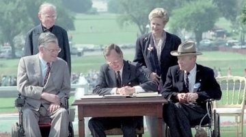 President George H.W. Bush signing the Americans with Disabilities Act (ADA), July 26, 1990.