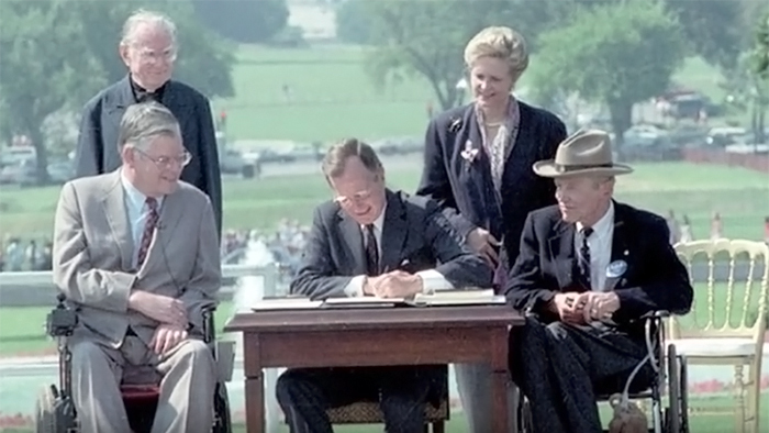 President George H.W. Bush signing the Americans with Disabilities Act (ADA), July 26, 1990.