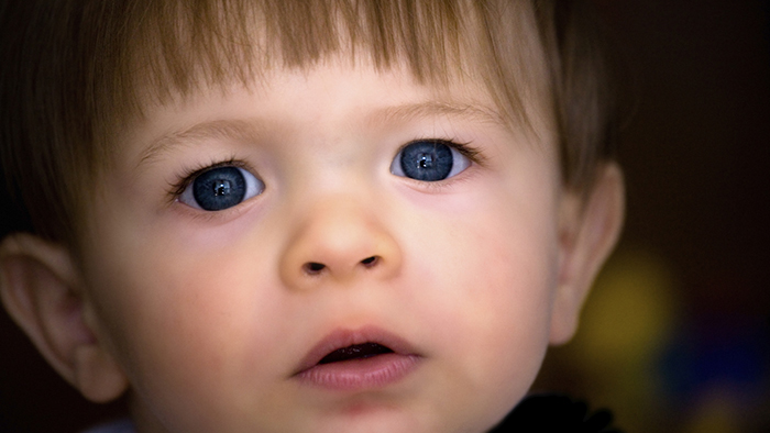 Portrait of a young boy with big blue eyes.