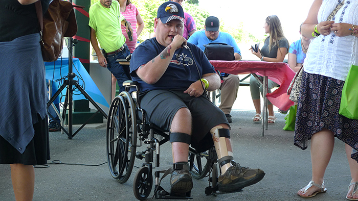 Disability Pride 2019 featured speaker, a man seated in a wheelchair addressing a crowd.