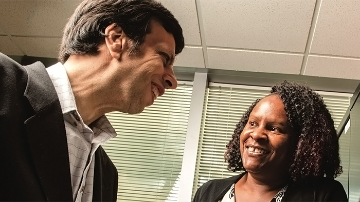 A man mentoring a woman employee.