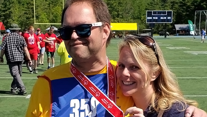 Eric and Tonya with their arms around each other at a 2019 Special Olympics event in Maine.