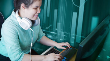 A blind woman with headphones who is typing on a braille keyboard. An artistic bar graph is overlayed in the teal background.