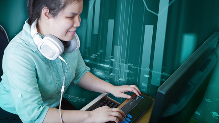 A blind woman with headphones who is typing on a braille keyboard. An artistic bar graph is overlayed in the teal background.