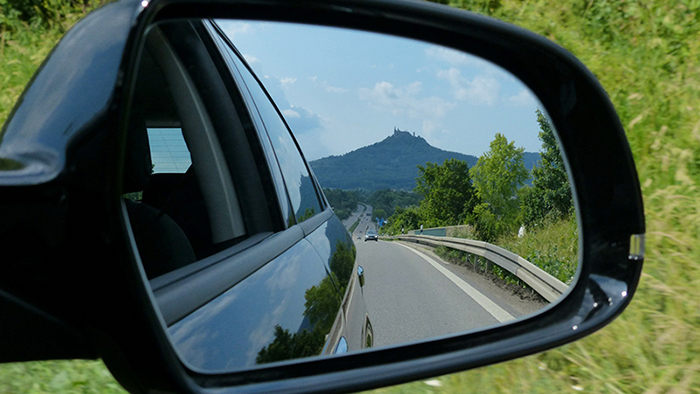 View of mountains in a rearview mirror.