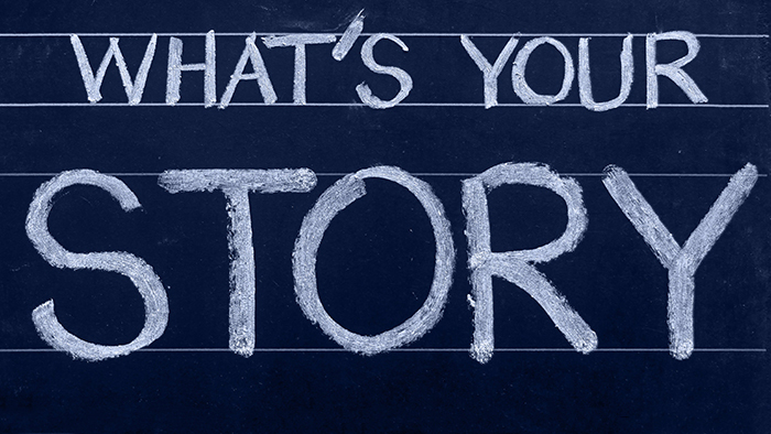 The words, "What's your story?" writen in chalk on a blackboard.