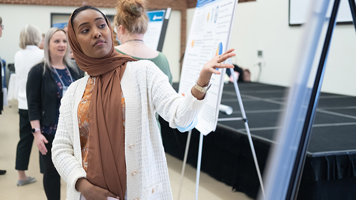 Hamda Ahmed presenting her capstone poster at UNH Graduate Research Conference.