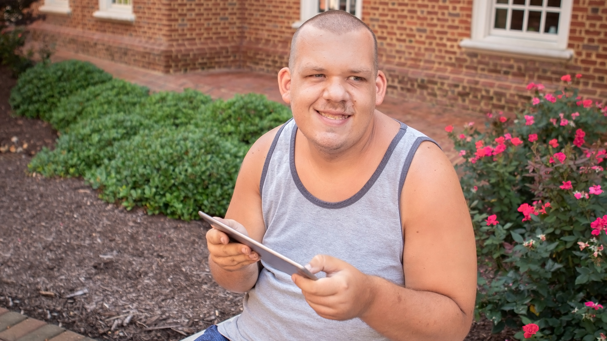 Portrait of an autistic man using a tablet.